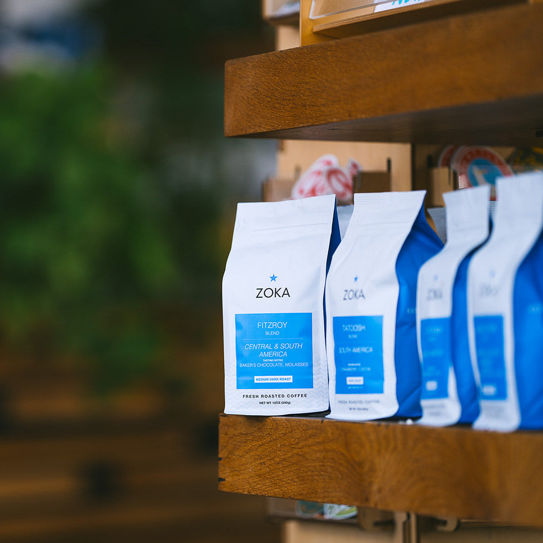 Zoka coffee bags on a wooden shelf.  